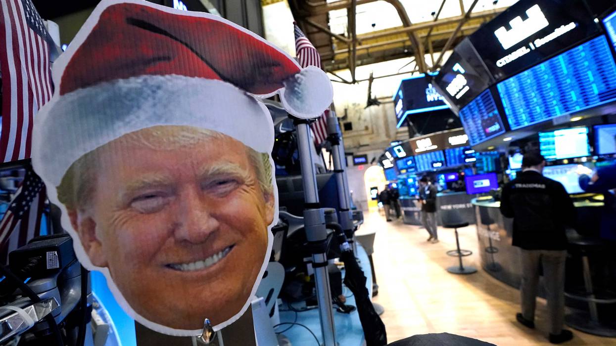 President-elect Donald Trump is displayed as traders work on the floor of the New York Stock Exchange (NYSE) at the opening bell