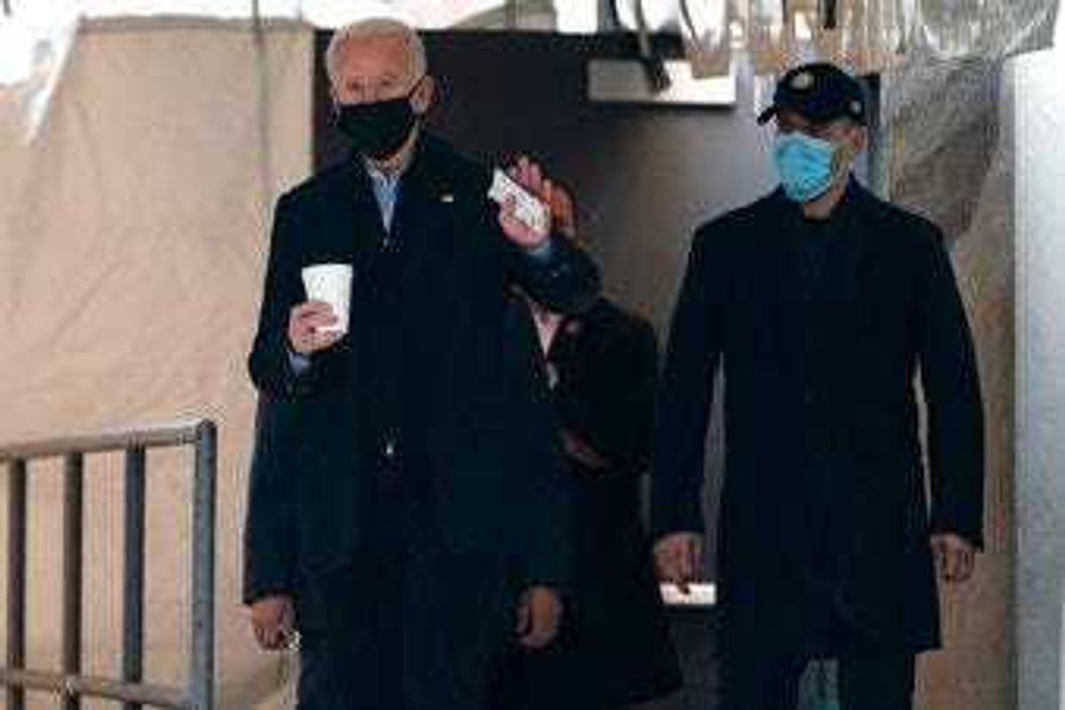 President-elect Joe Biden waves to reporters as walks out of The Queen theater Monday, Jan. 18, 2021, in Wilmington, Del. (AP Photo/Evan Vucci)