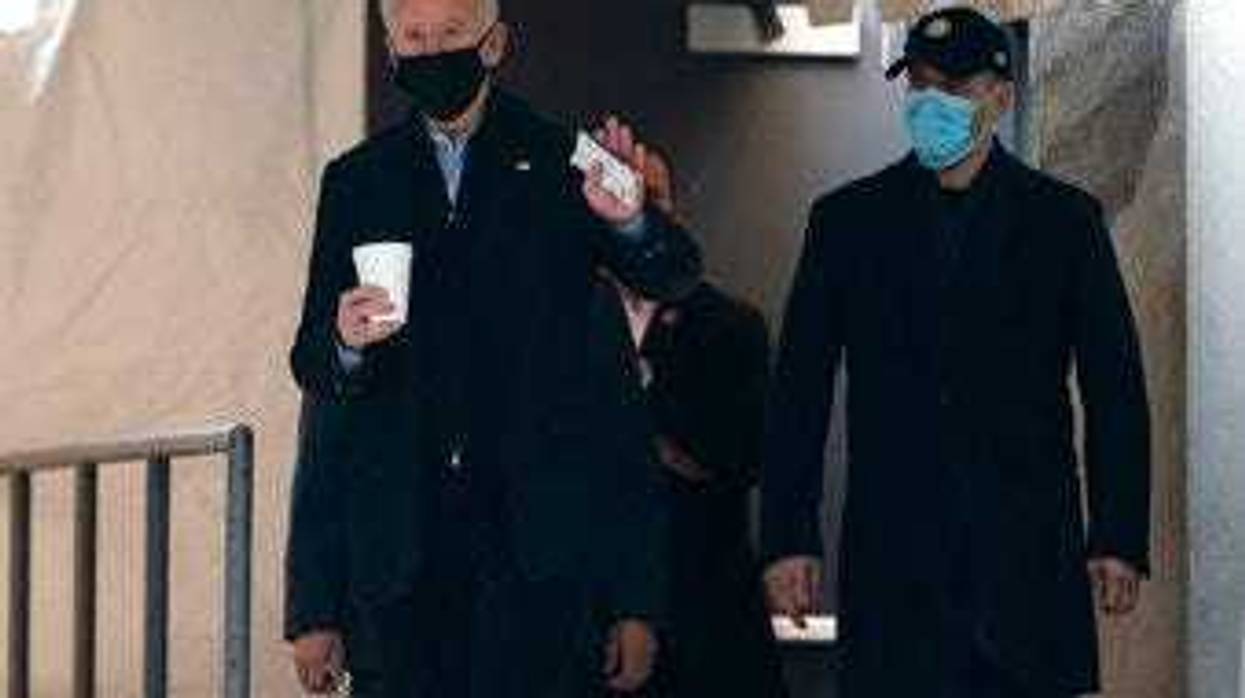 President-elect Joe Biden waves to reporters as walks out of The Queen theater Monday, Jan. 18, 2021, in Wilmington, Del. (AP Photo/Evan Vucci)
