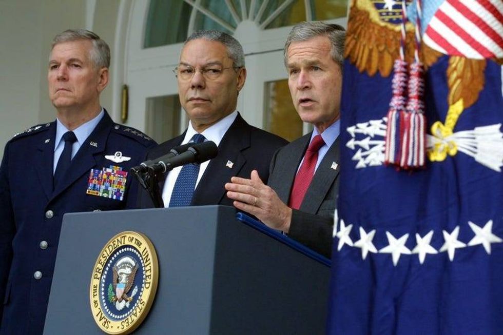 President George W. Bush (R) speaks as Secretary of State Colin Powell (C) and the Chairman of the Joint Chiefs of Staff Richard Myers listen December 13, 2001 during an announcement of a withdraw from the 1972 Anti-Ballistic Missile Treaty at the Rose garden of the White House in Washington, DC.