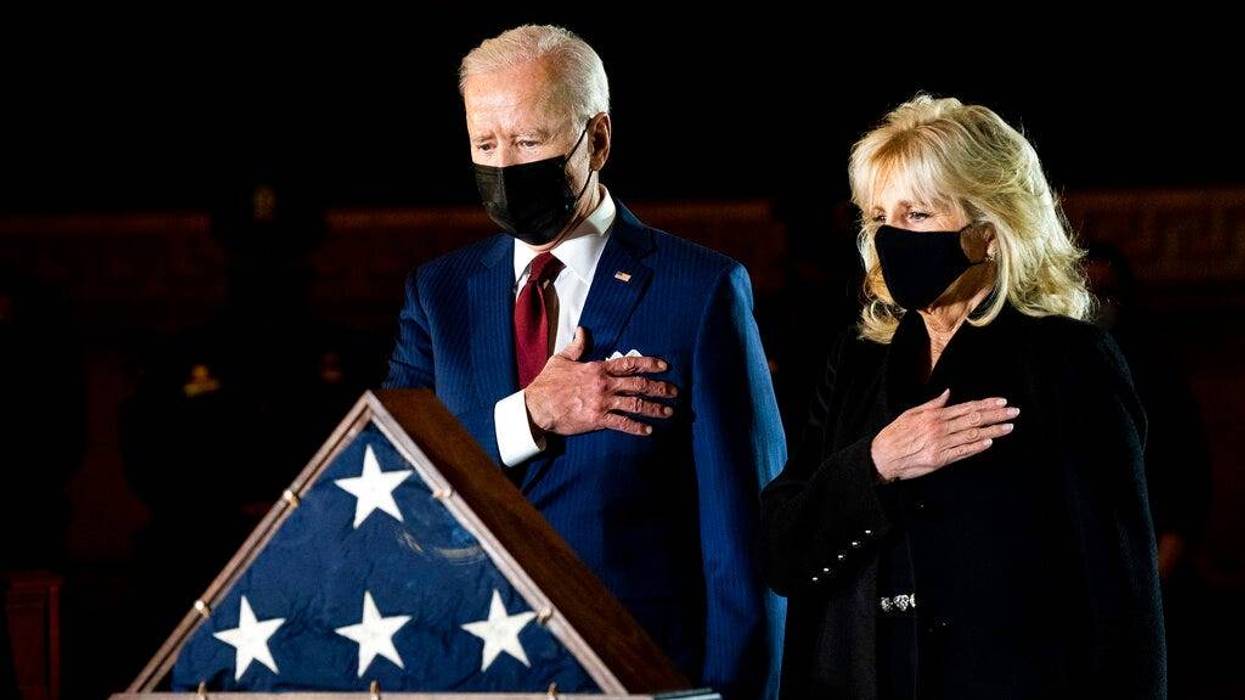 President Joe Biden and first lady Jill Biden pay their respects to the late U.S. Capitol Police officer Brian Sicknick as an urn with his cremated remains lies in honor on a black-draped table at the center of Capitol Rotunda, Tuesday, Feb. 2, 2021, in Washington. (Erin Schaff/The New York Times via AP, Pool)