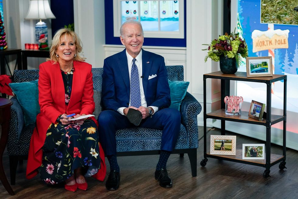 President Joe Biden and first lady Jill Biden speak with the NORAD Tracks Santa Operations Center on Peterson Air Force Base, Colo., via teleconference in the South Court Auditorium on the White House campus in Washington, Friday, Dec. 24, 2021