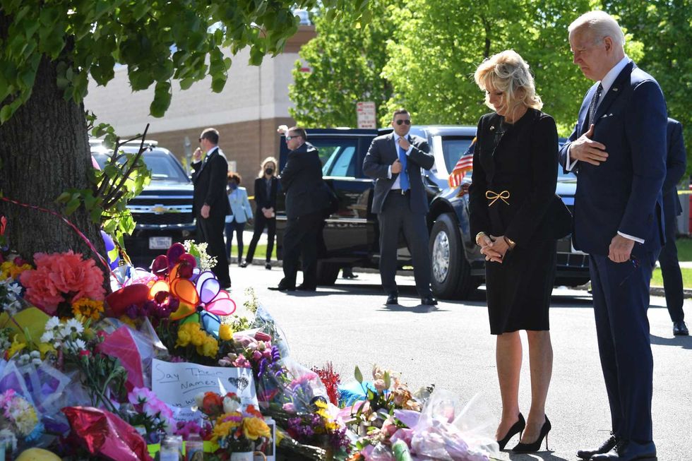 President Joe Biden and First Lady Jill Biden visit a memorial near a Tops grocery store in Buffalo, New York, on May 17, 2022. Biden is visiting Buffalo after ten people were killed in a mass shooting at a grocery store on May 14, 2022