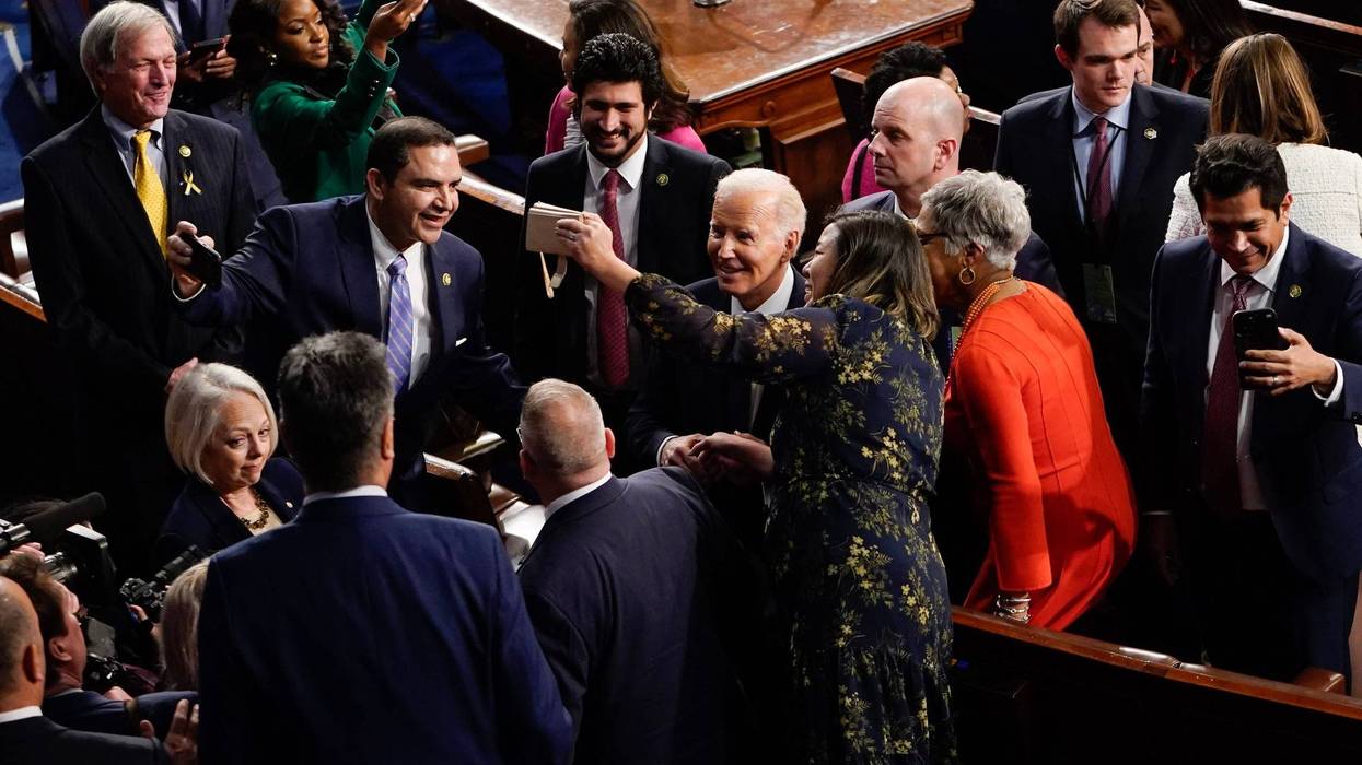 President Joe Biden chats with members of Congress after the State of the Union address from the House chamber of the United States Capitol in Washington.