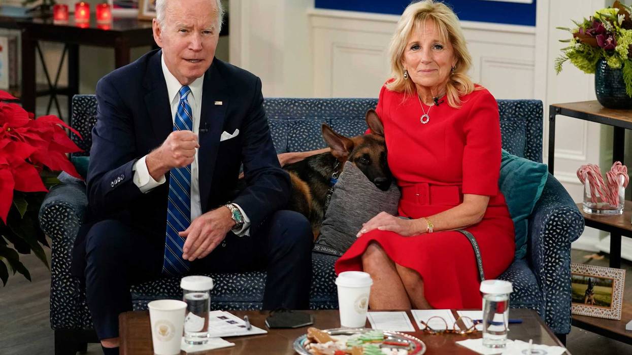 President Joe Biden, first lady Jill Biden and their new dog Commander, a purebred German shepherd puppy, meet virtually with service members around the world, Saturday, Dec. 25, 2021, in the South Court Auditorium on the White House campus in Washington, to thank them for their service and wish them a Merry Christmas