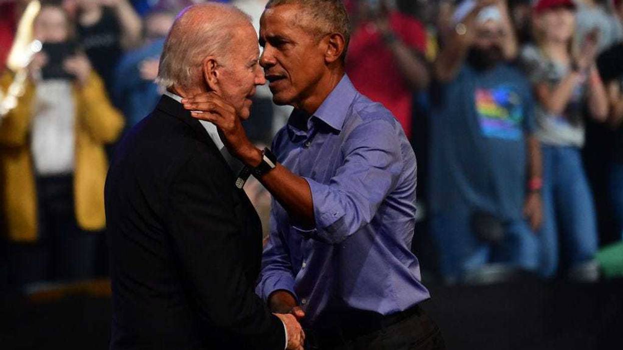 President Joe Biden (L) and former U.S. President Barack Obama (R) embrace on stage during a rally on November 5, 2022.