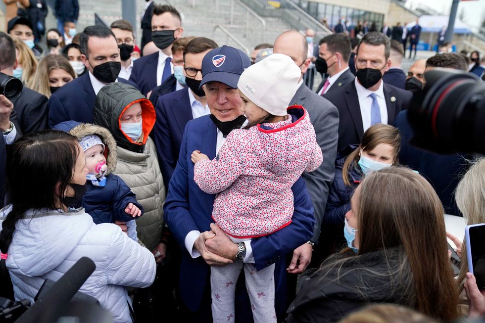 President Joe Biden meets with Ukrainian refugees and humanitarian aid workers during a visit to PGE Narodowy Stadium, Saturday, March 26, 2022, in Warsaw.