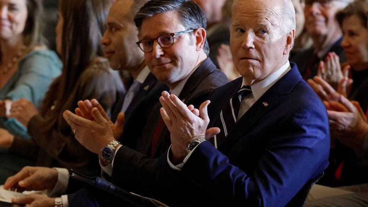 President Joe Biden (R) and Speaker of the House Mike Johnson (R-LA) applaud for Andrea Bocelli after he performed "Amazing Grace" during the annual National Prayer Breakfast in Statuary Hall in the U.S. Capitol on February 01, 2024 in Washington, DC. The gathering of elite political, social and business leaders has been attended by every president since Dwight D. Eisenhower. This is the first year the event is being hosted by the National Prayer Breakfast Foundation inside the Capitol after being controlled for decades by the Christian evangelical group the Fellowship Foundation. (Photo by Chip Somodevilla/Getty Images)