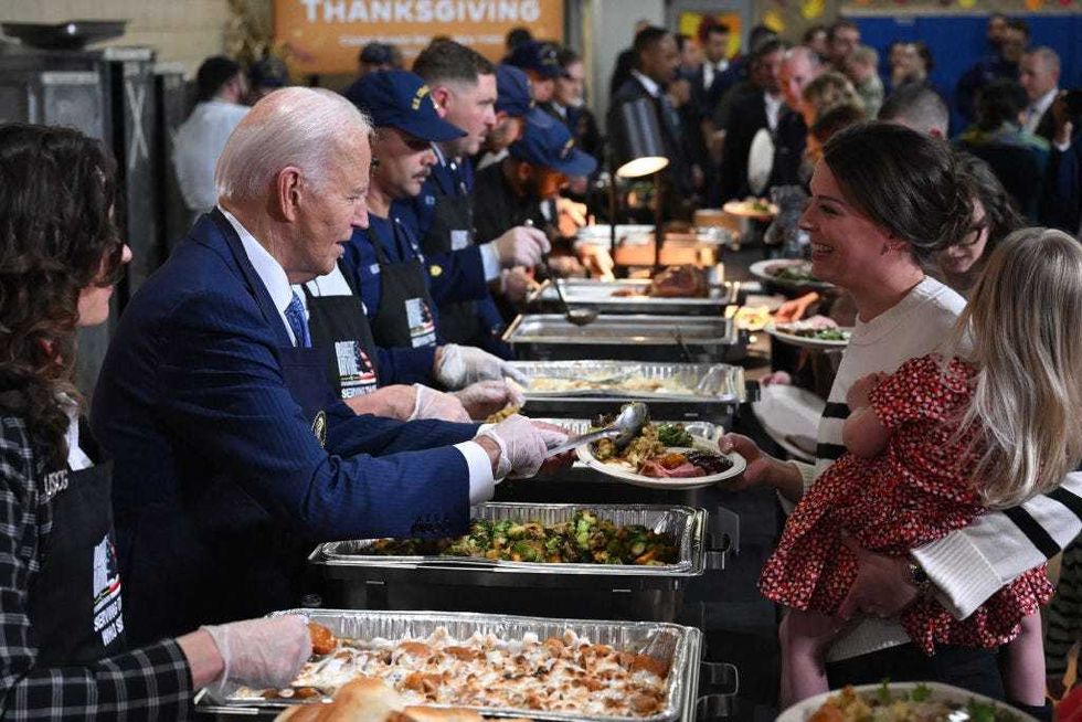 President Joe Biden serves food at a "Friendsgiving" dinner in honor of the upcoming Thanksgiving holiday with service members and their families at the Coast Guard Sector New York in Staten Island on Nov. 25, 2024.