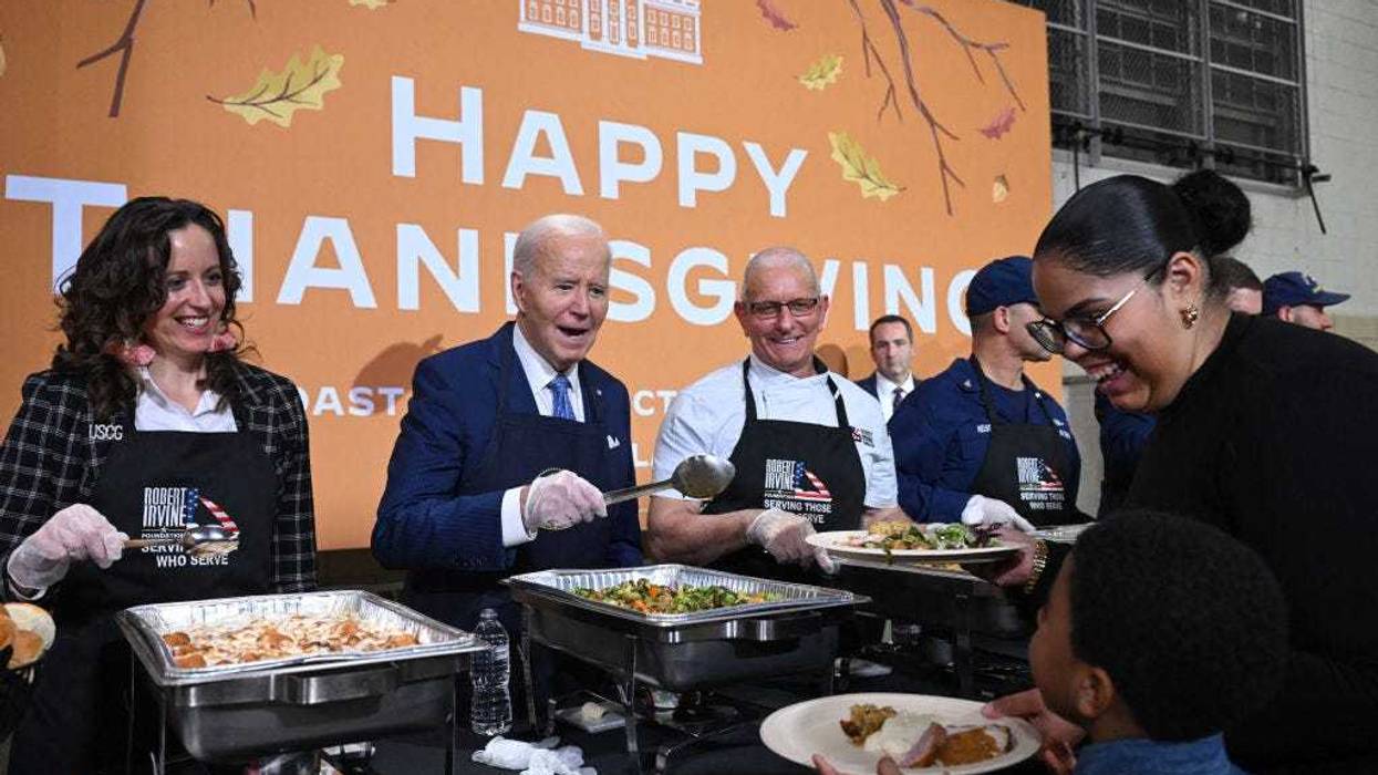 President Joe Biden serves food at a "Friendsgiving" dinner in honor of the upcoming Thanksgiving holiday with service members and their families at the Coast Guard Sector New York in Staten Island, New York, on Nov. 25, 2024.