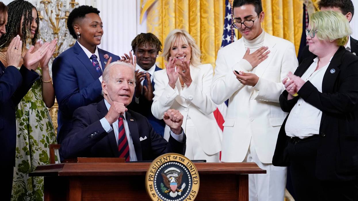 President Joe Biden signs an executive order at an event to celebrate Pride Month in the East Room of the White House