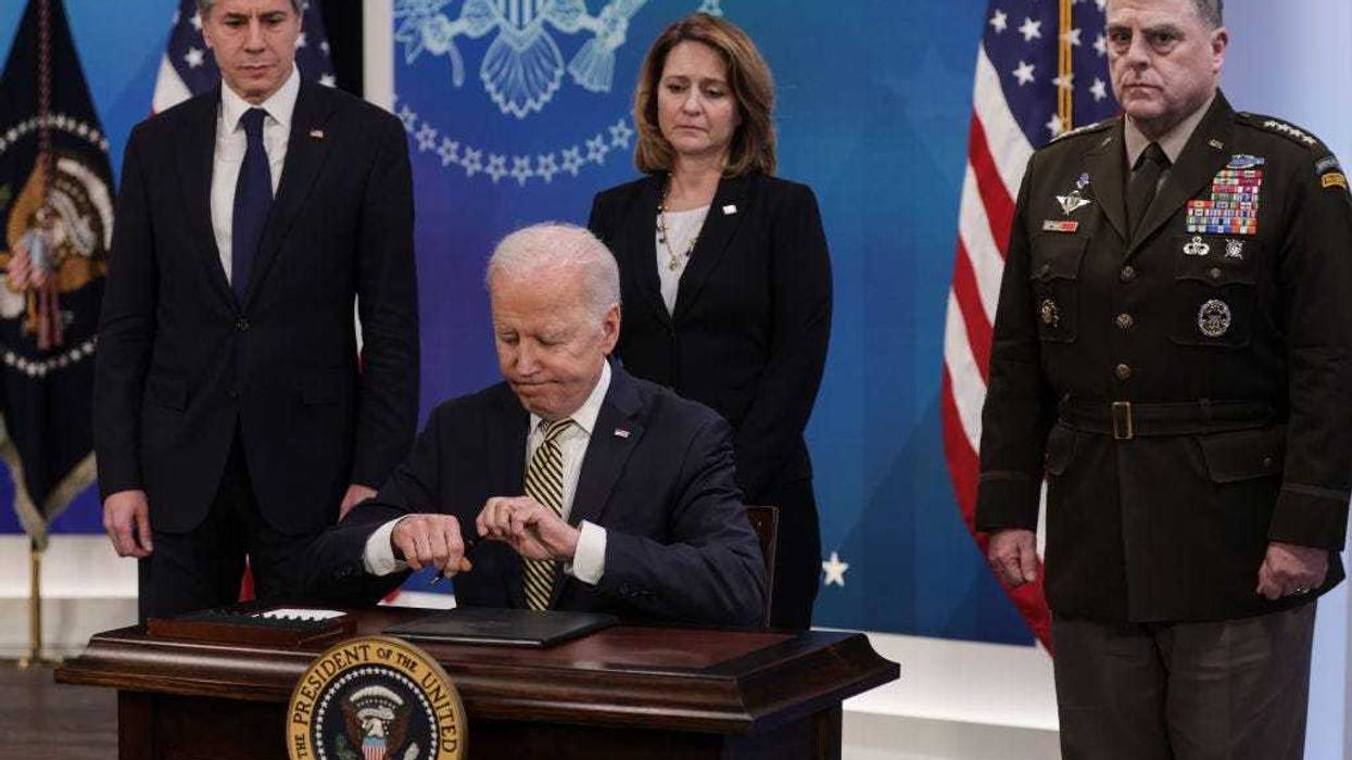 President Joe Biden signs legislative action to provide security aid and support to Ukraine as Secretary of State Antony Blinken (L), Deputy Secretary of Defense Kathleen Hicks and Chairman of the Joint Chiefs of Staff General Mark Milley look on, during an event in the South Court Auditorium at the Eisenhower Executive Office Building near the White House on March 16, 2022 in Washington, DC. President Biden delivered remarks on U.S. assistance to Ukraine as Russia's invasion of Ukraine enters its third week.