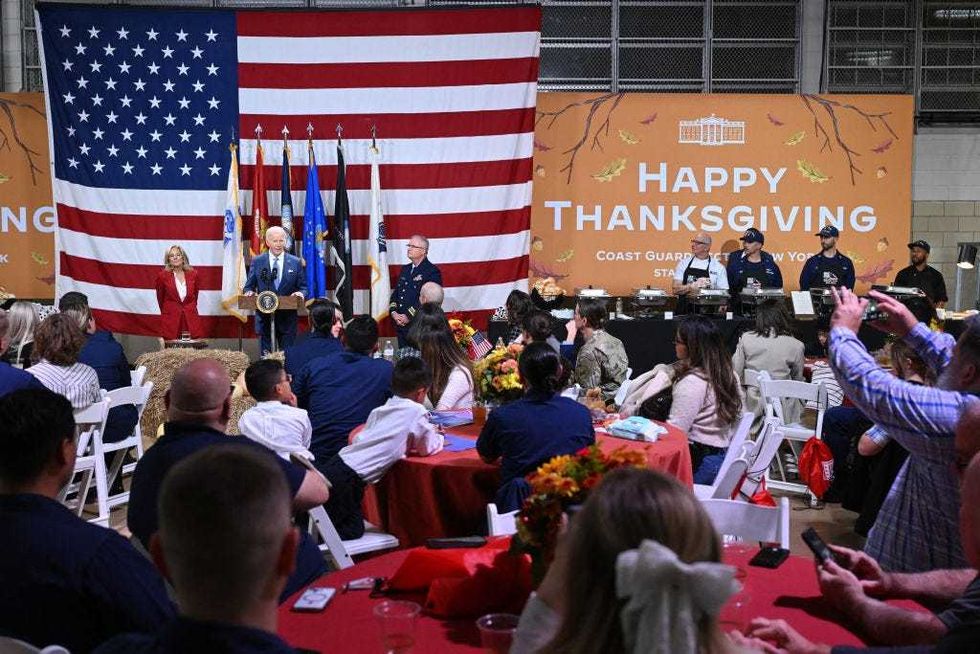 President Joe Biden speaks, flanked by First Lady Dr. Jill Biden, during a "Friendsgiving" dinner in honor of the upcoming Thanksgiving holiday with service members and their families at the Coast Guard Sector New York in Staten Island on Nov. 25, 2024.