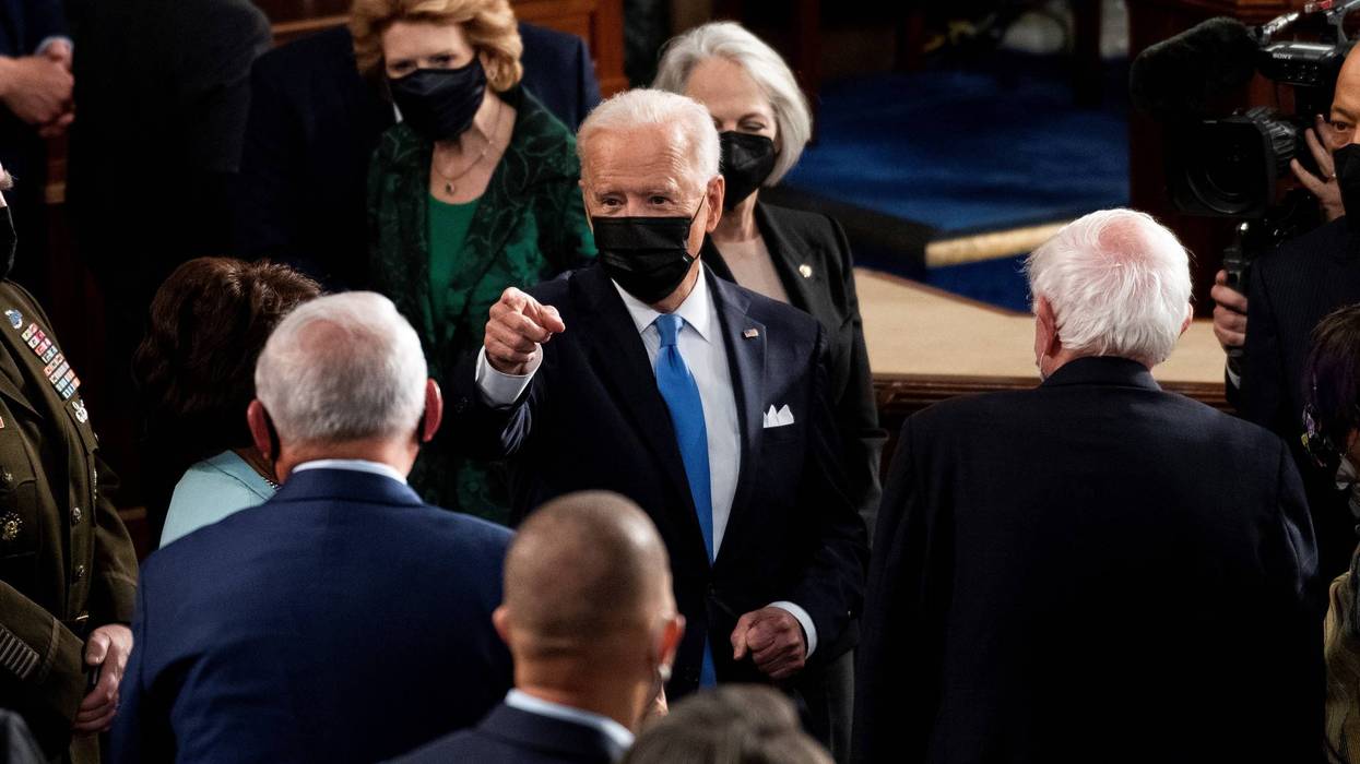 President Joe Biden speaks with lawmakers as he exits the House chamber at the end of his address to the joint session of Congress in the House chamber of the U.S. Capitol April 28, 2021 in Washington, DC.