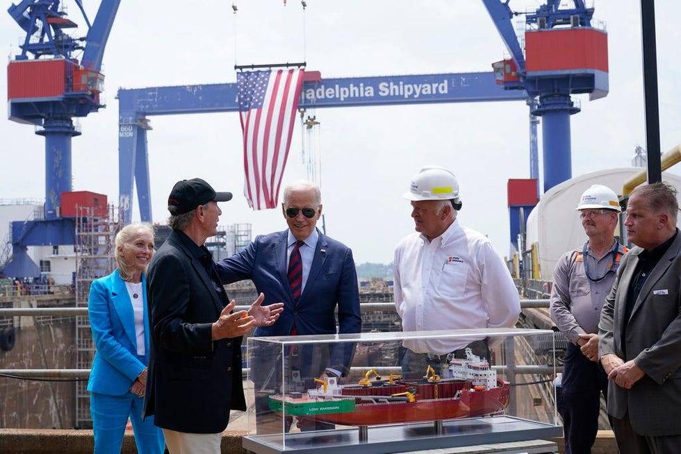 President Joe Biden talks with Lasse Petterson, CEO of Great Lakes Dredge and Dock, second from left, as he tours a shipyard in Philadelphia, Thursday, July 20, 2023. Rep. Mary Gay Scanlon, D-Pa., left, and Steinar Nerbovik, CEO of Philadelphia Shipyard, Inc., third from right, look on.