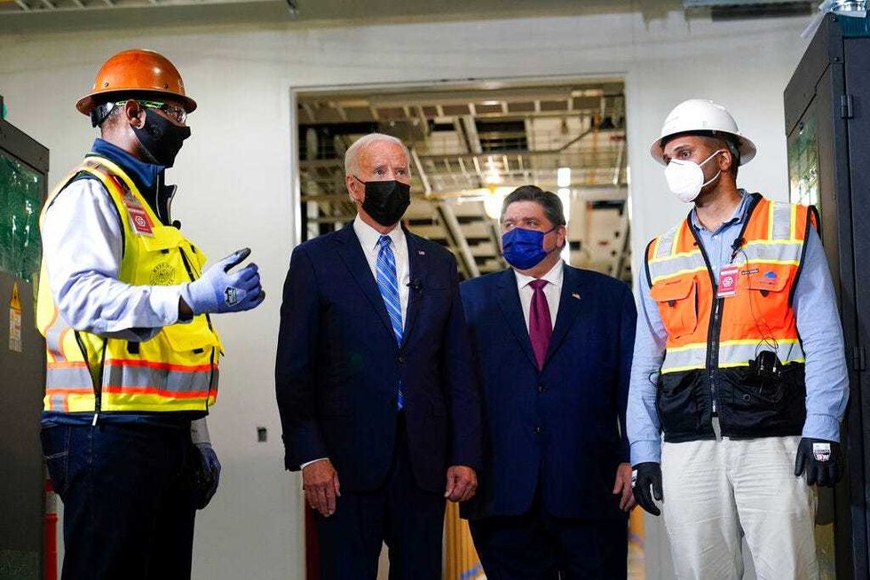 President Joe Biden tours a Clayco Corporation construction site for a Microsoft data center in Elk Grove Village, Ill., Thursday, Oct. 7, 2021, with Otto Nichols, left, and Anuraj Jhajj and Illinois Gov. J.B. Pritzker.