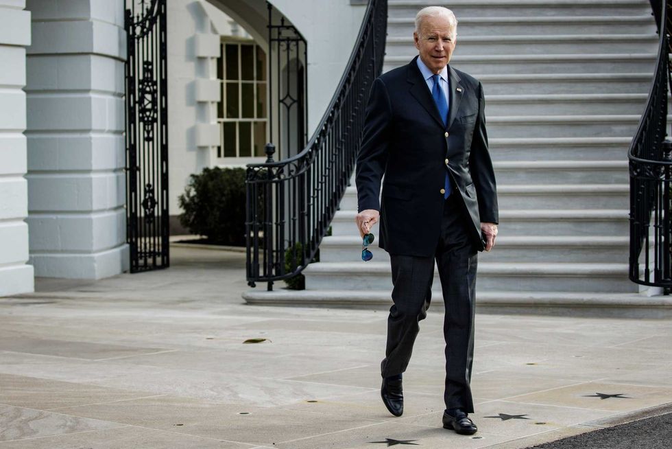 President Joe Biden walks on the South Lawn of the White House before boarding Marine One in Washington on Wednesday, March 23, 2022
