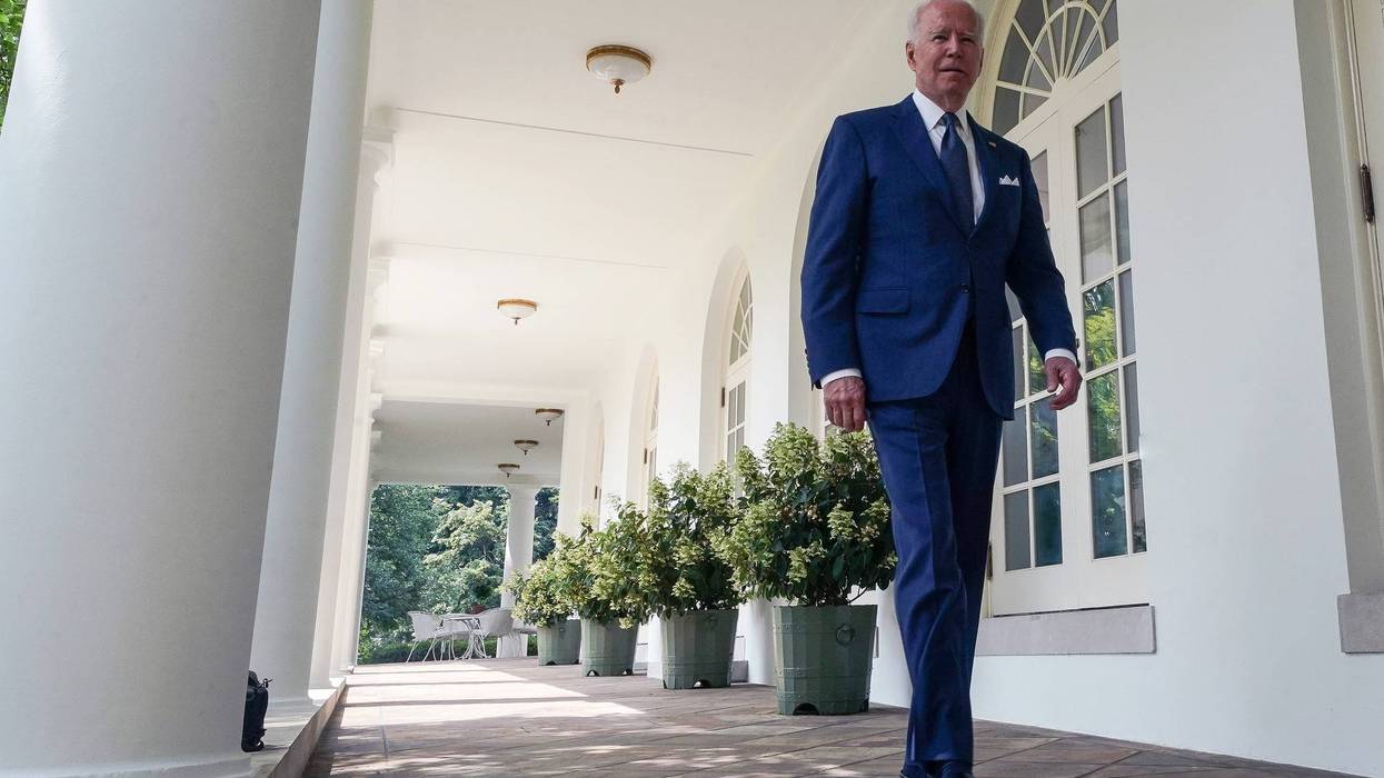 President Joe Biden walks to the White House Rose Garden.