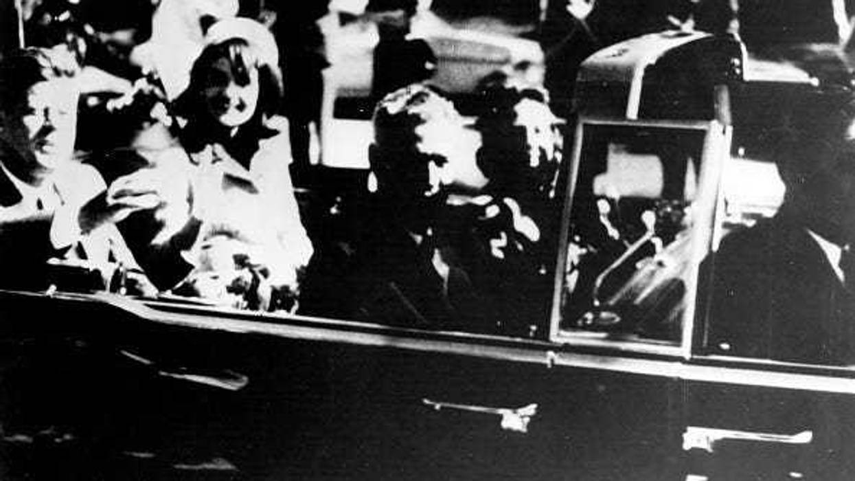 President John F. Kennedy (1917 - 1963) and First Lady Jacqueline Kennedy ride with Texas Governor John Connally and others in an open car motorcade shortly before the president was assassinated in Dallas, Texas, November 22, 1963. (Photo by Keystone/Getty Images)
