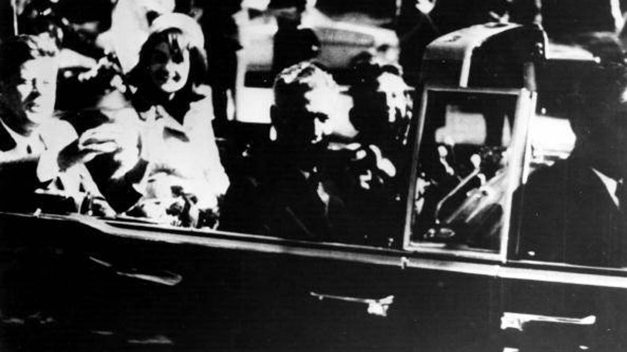 President John F. Kennedy (1917 - 1963) and his wife Jacqueline Kennedy ride with secret agents in an open car motorcade shortly before the president was assassinated in Dallas, Texas, November 22, 1963.