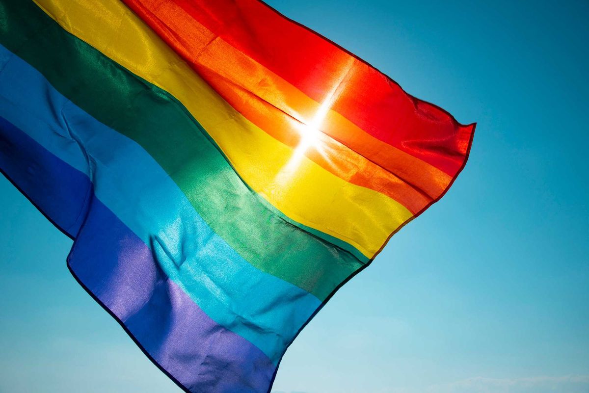 Pride flag in the wind stock photo.