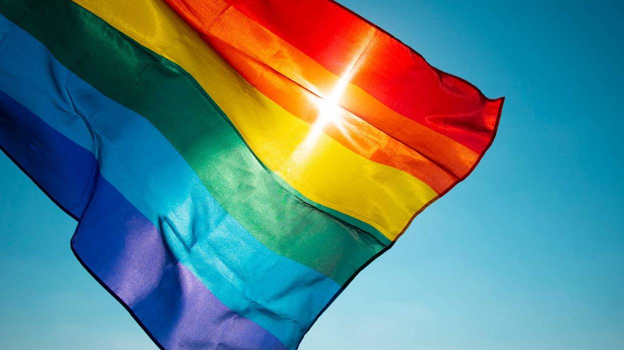 Pride flag in the wind stock photo.