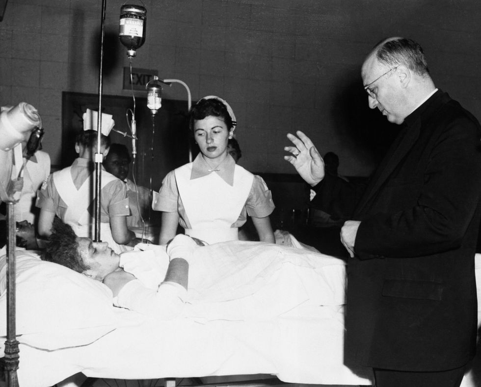 priest blessing child patient