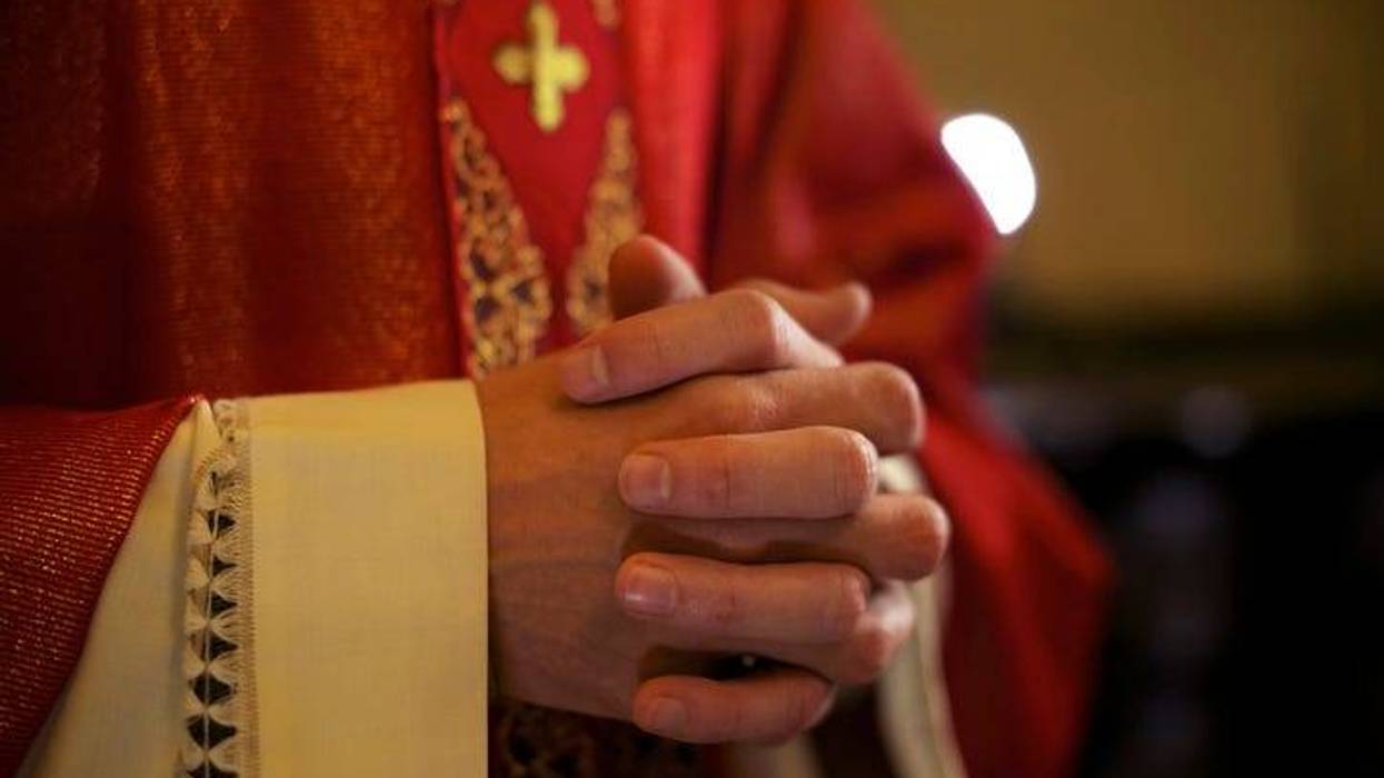Priest folding hands