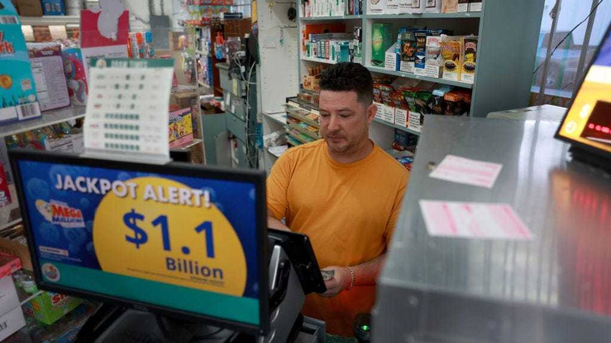 Printing out a Mega Million lottery ticket for a customer. The Mega Millions jackpot has reached over $1.15 billion for tonight's drawing.