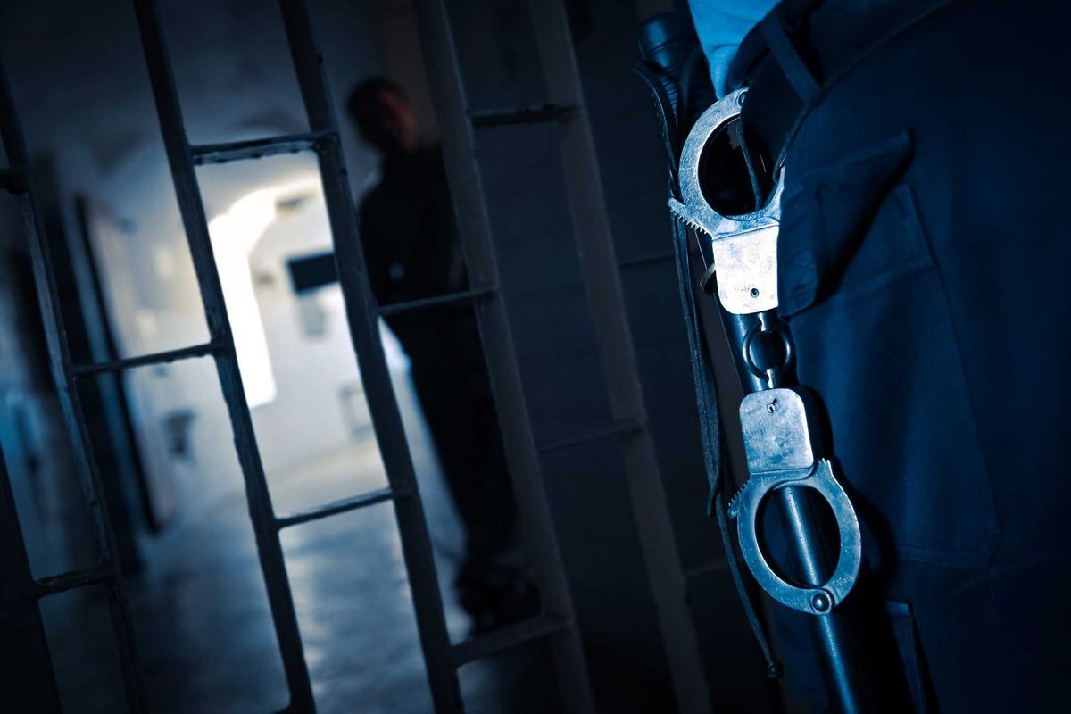 Prison guard and handcuffs stock photo.