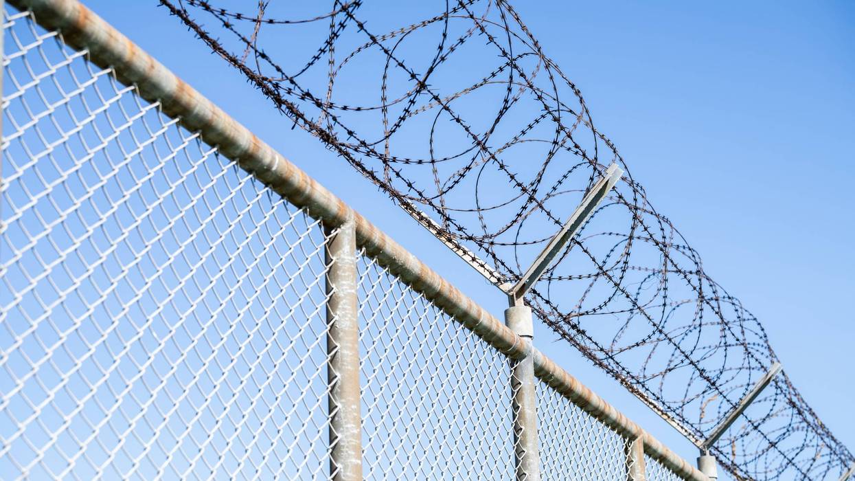 Prison security fence. Barbed wire security fence. Razor wire jail fence. Barrier border. Boundary security wall. Prison for arrest criminals or terrorists. Private area. Military zone concept.