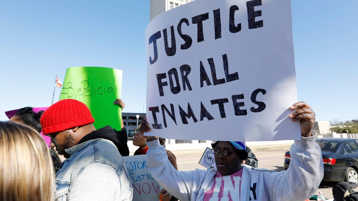 Prisoner advocates hold signs supporting inmate rights at a protest outside the Capitol in Jackson, Miss., Tuesday, Jan. 7, 2020.