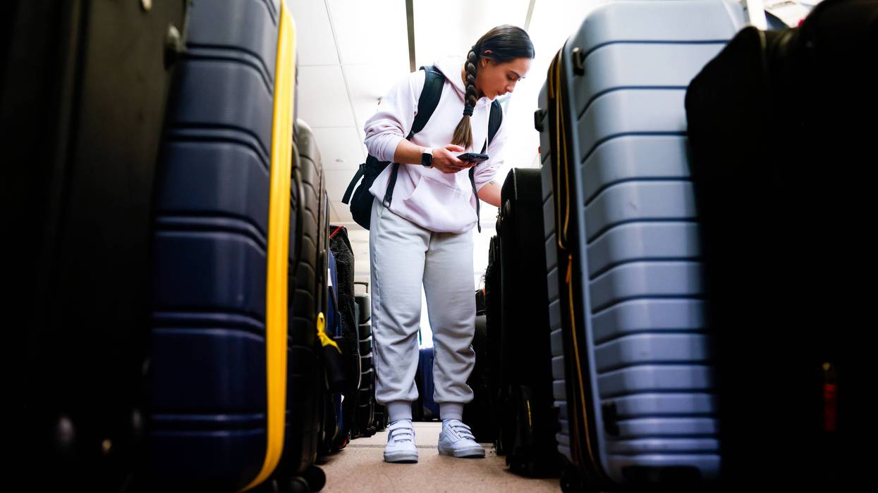 Pristine Floyde searches for a friend's suitcase in a baggage holding area for Southwest Airlines at Denver International Airport on Dec. 28, 2022, in Denver, Colorado.
