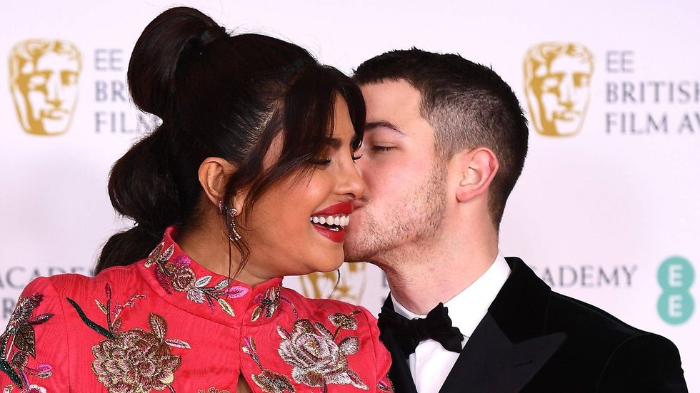 Nick Jonas turns Priyanka Chopra into an actual snack, eating off her backside in bikini photo