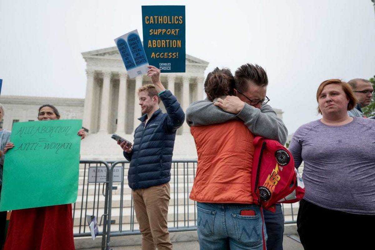 Pro-choice activists embrace as they demonstrate in front of the U.S. Supreme Court Building on May 03, 2022 in Washington, DC. In a leaked initial draft majority opinion obtained by Politico, Supreme Court Justice Samuel Alito allegedly wrote that the cases Roe v. Wade and Planned Parenthood of Southeastern Pennsylvania v. Casey should be overturned, which would end federal protection of abortion rights across the country. (Photo by Anna Moneymaker/Getty Images)