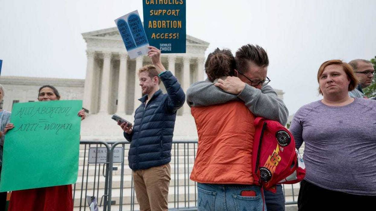 Pro-choice activists embrace as they demonstrate in front of the U.S. Supreme Court Building on May 03, 2022 in Washington, DC. In a leaked initial draft majority opinion obtained by Politico, Supreme Court Justice Samuel Alito allegedly wrote that the cases Roe v. Wade and Planned Parenthood of Southeastern Pennsylvania v. Casey should be overturned, which would end federal protection of abortion rights across the country. (Photo by Anna Moneymaker/Getty Images)