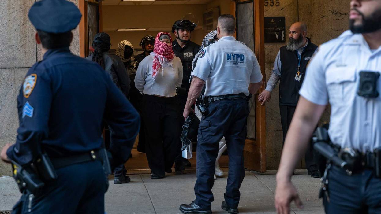 Pro-Palestinian protesters are escorted out of Columbia University's Butler Library after their arrest for occupying the library space on May 7, 2025