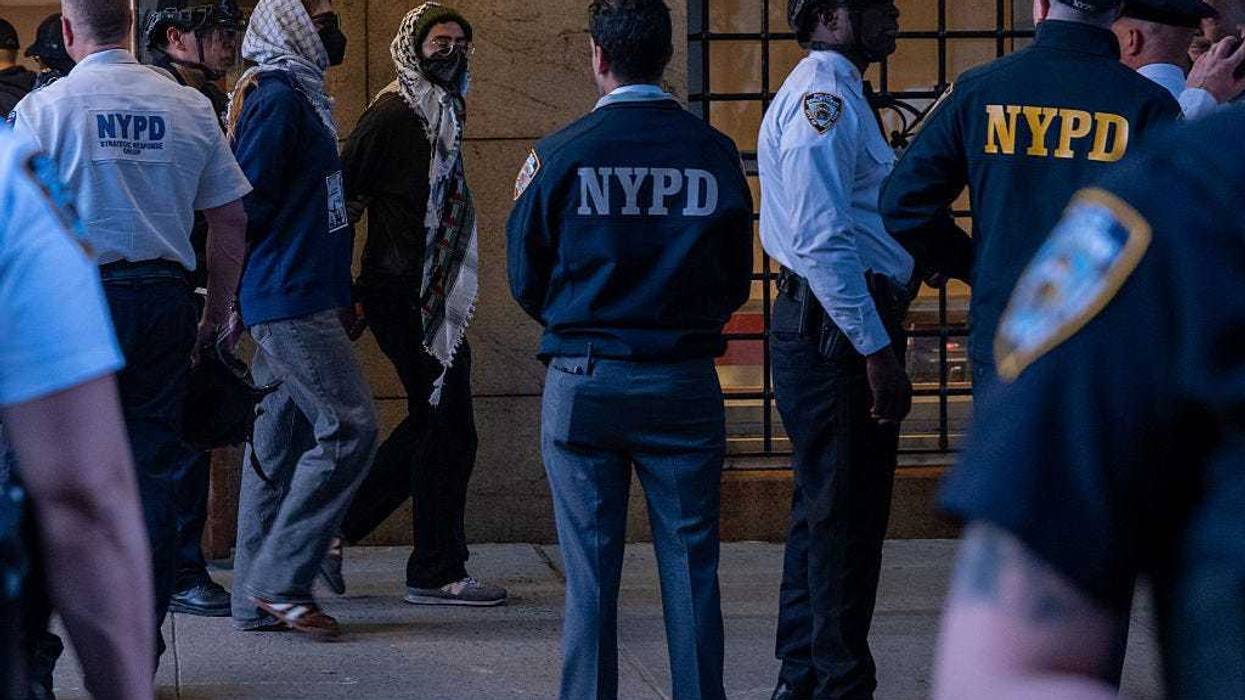 Pro-Palestinian protesters are escorted out of Columbia University's Butler Library after their arrest for occupying the library space on May 7, 2025 in New York City. Crowds of protesters grew as a standoff with security at the library continued into the evening.