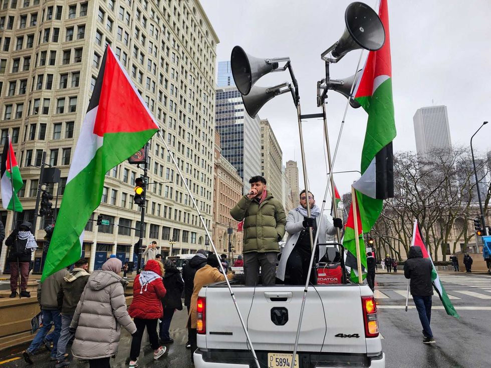 Pro-Palestinian protesters march down Michigan Avenue on New Year