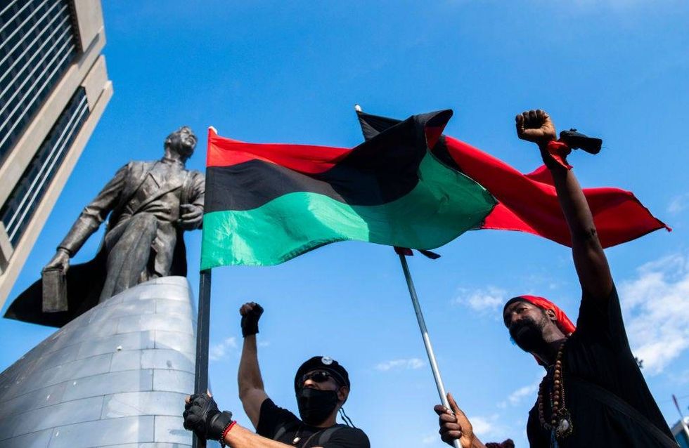 Protester chant near the Adam Clayton Powell Jr. statue during a Juneteenth celebration on June 19, 2020 in New York City