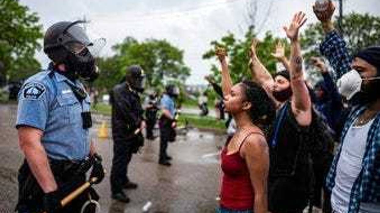 Protesters and police face each other during a rally for George Floyd in Minneapolis on Tuesday, May 26, 2020. (Richard Tsong-Taatarii/Star Tribune via AP)
