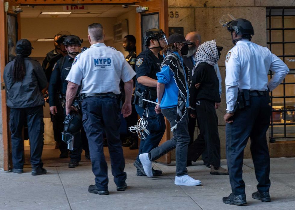 Protesters are escorted out of Columbia University