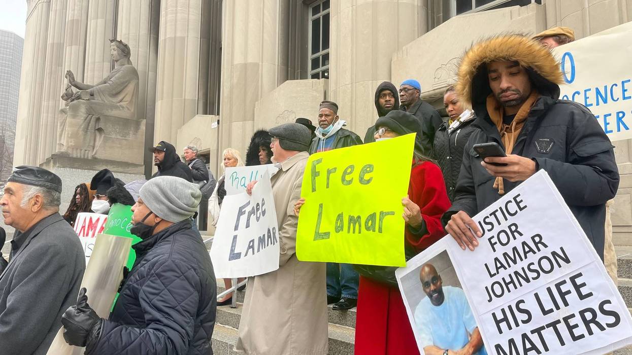protesters at courthouse with signs that say 'free lamar' and 'justice for lamar johnson, his life matters'