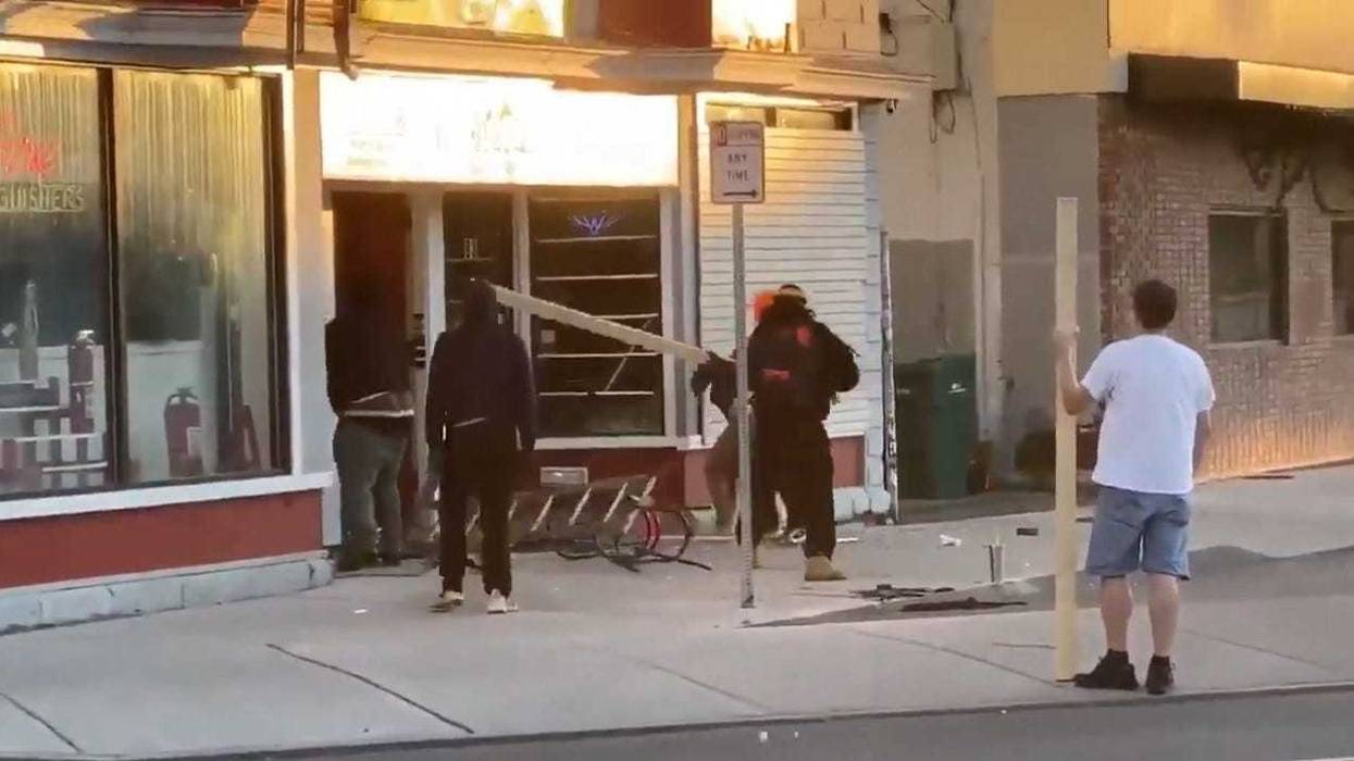 Protesters beat woman