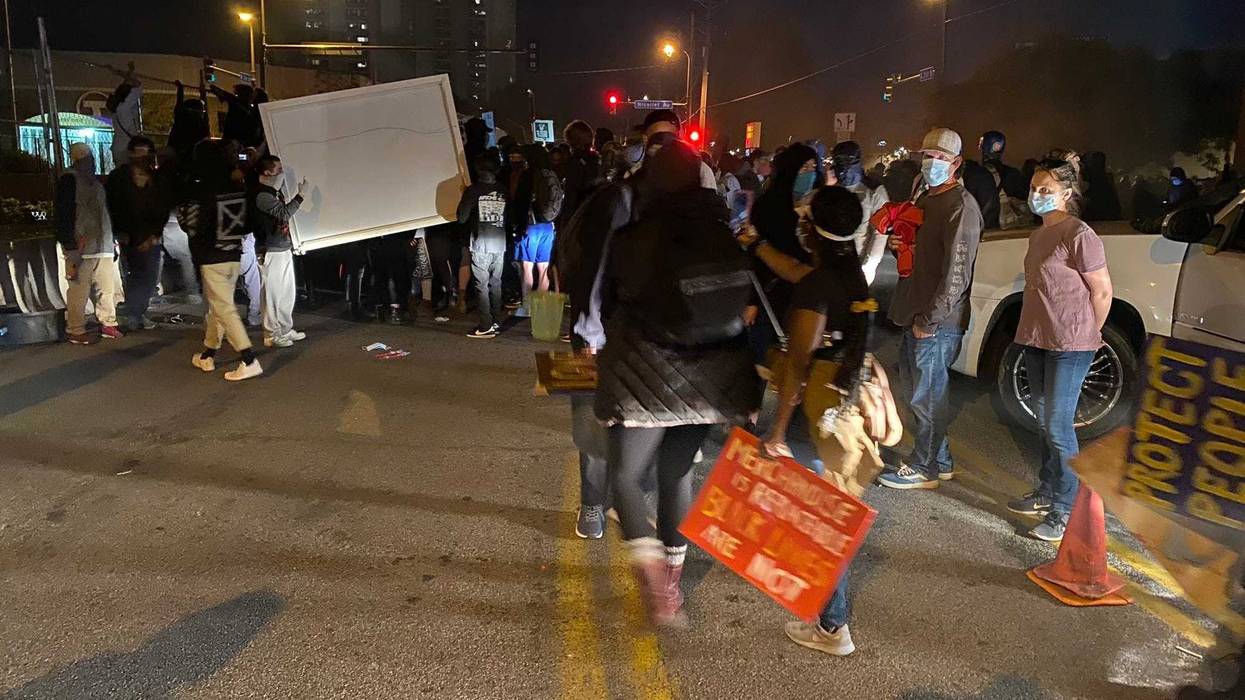 Protesters carrying large item