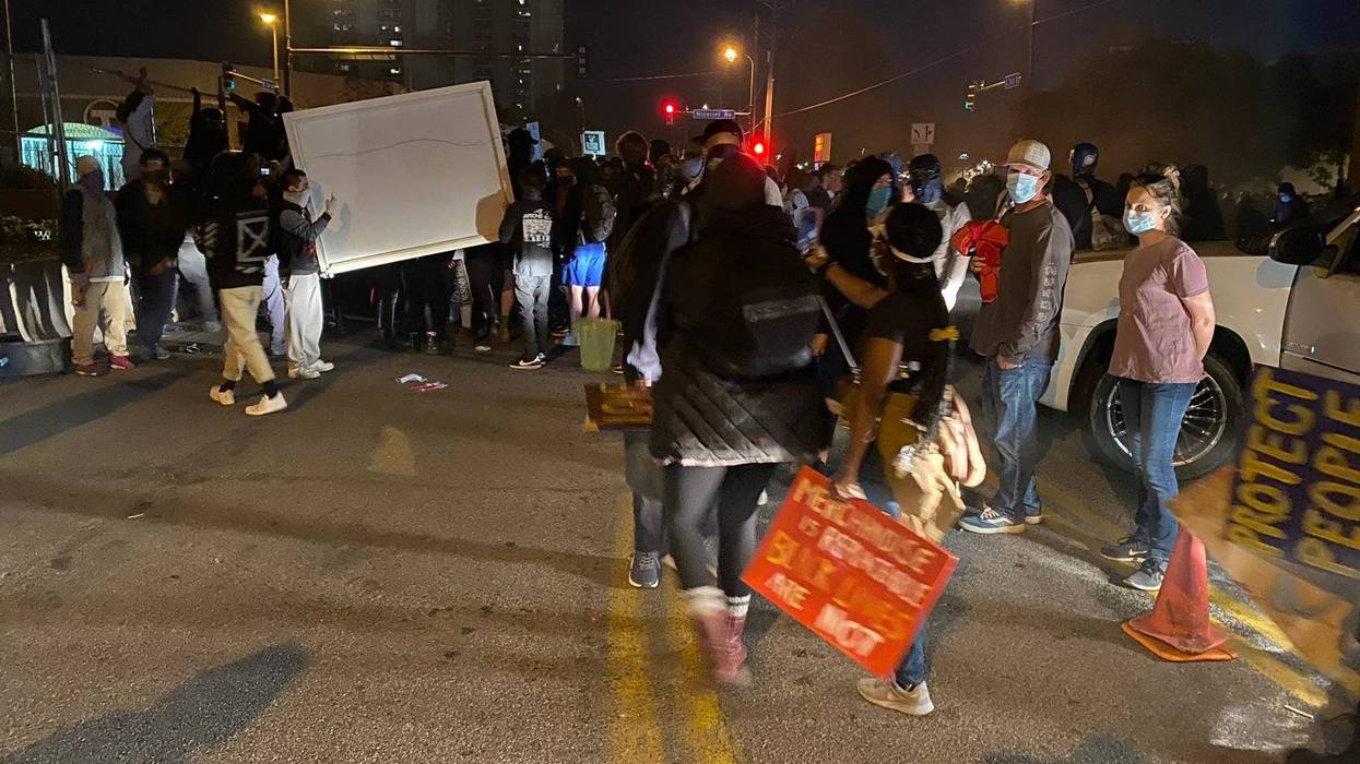 Protesters carrying large item