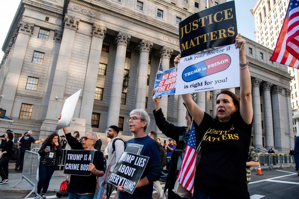 Protesters chant outside New York Supreme Court ahead of Donald Trump