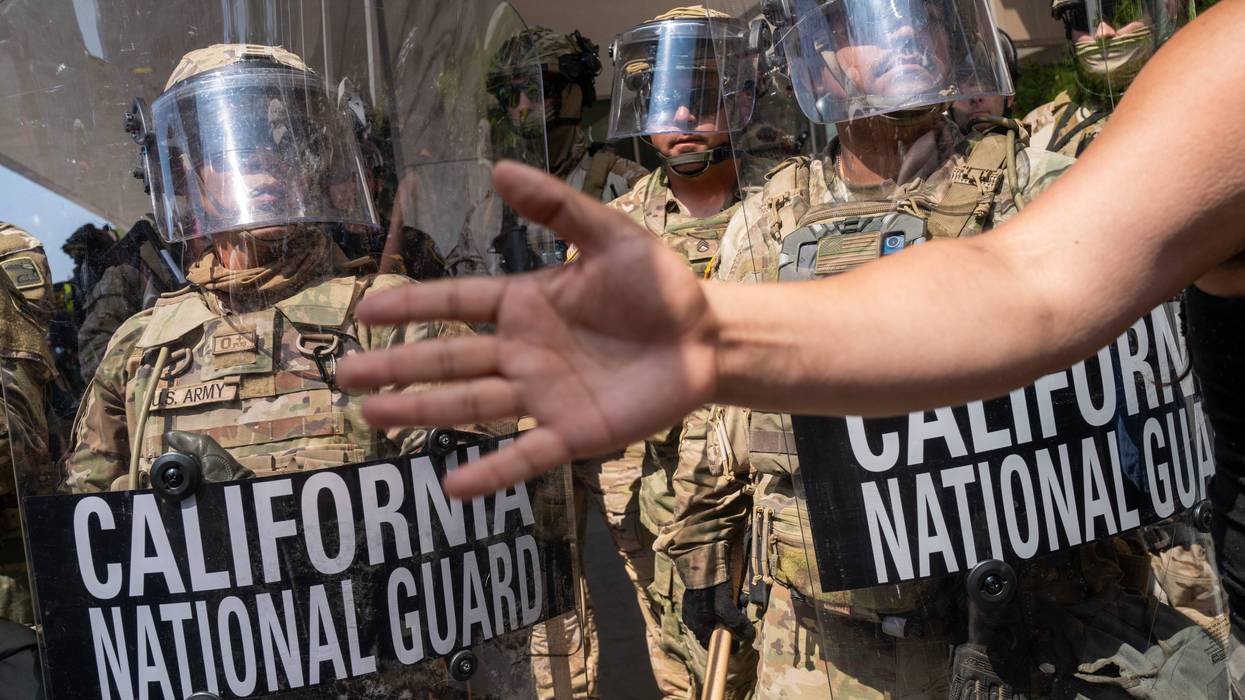 Protesters confront National Guard soldiers and police outside of a federal building as protests continue in Los Angeles following three days of clashes with police after a series of immigration raids on June 09, 2025, in Los Angeles, California.