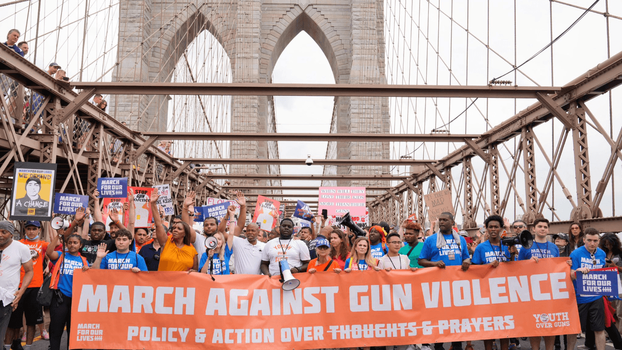 Protesters demanding federal legislation to combat gun violence march across the Brooklyn Bridge.