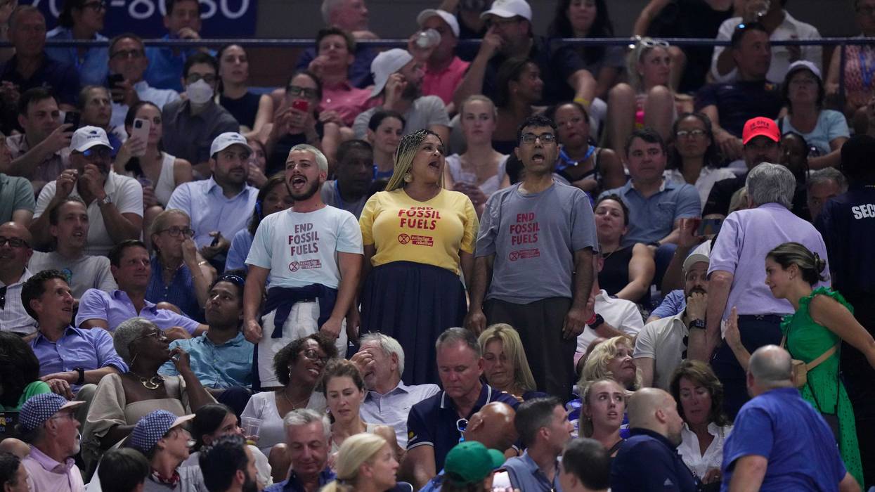 Protesters demonstrate at a match between Coco Gauff, of the United States, and Karolina Muchova, of the Czech Republic, during the women's singles semifinals of the U.S. Open tennis championships, Thursday, Sept. 7, 2023, in New York